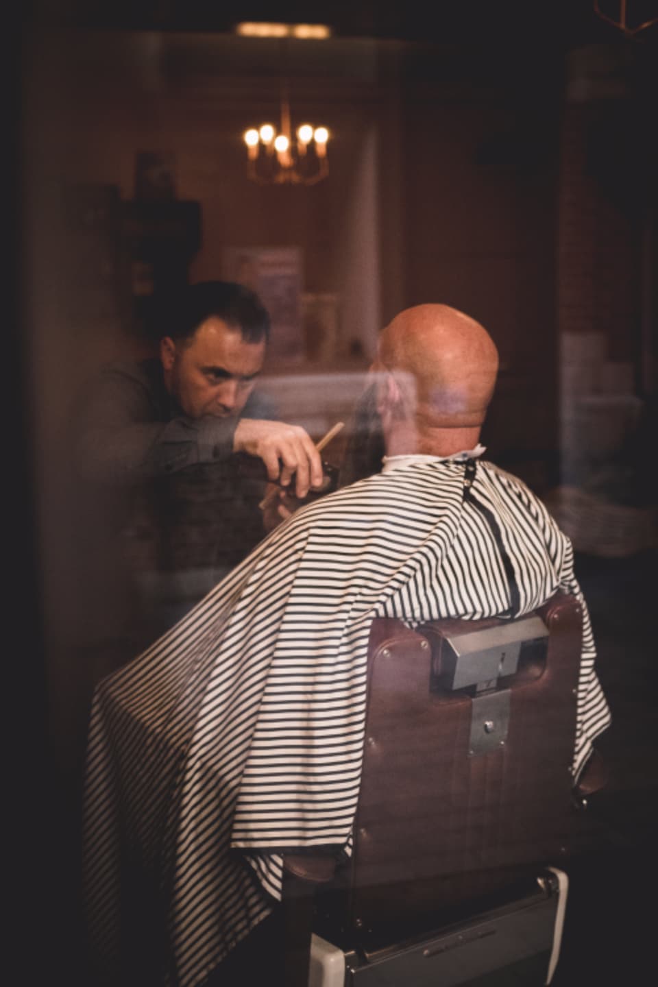 A barber cutting a customer’s hair