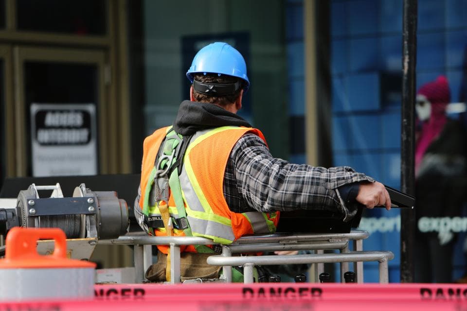 A construction worker in a hard hat and high-visibility vest