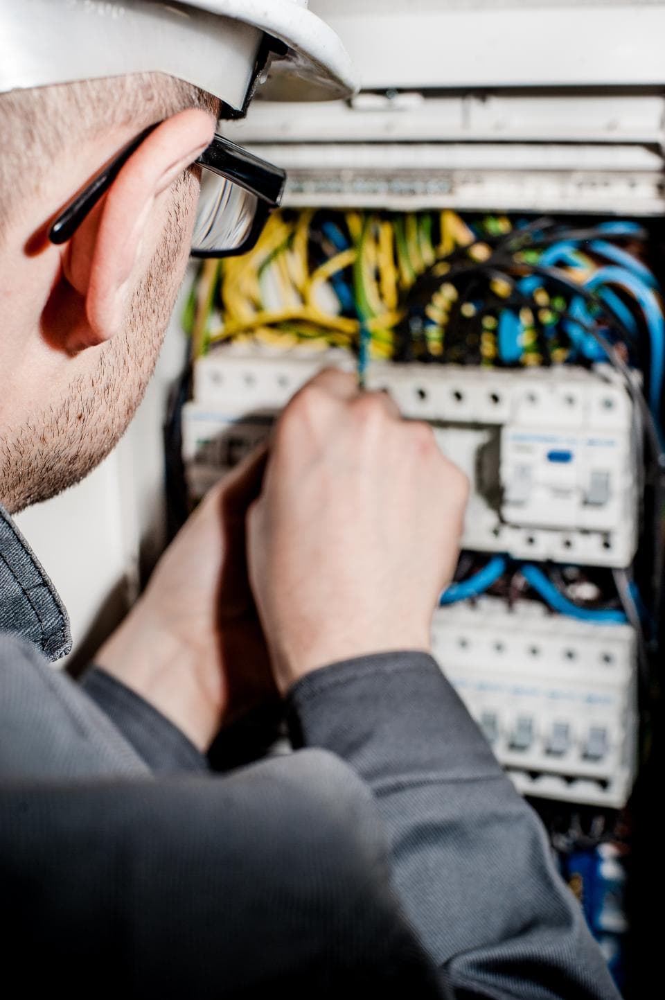 An electrician wiring a fuse board