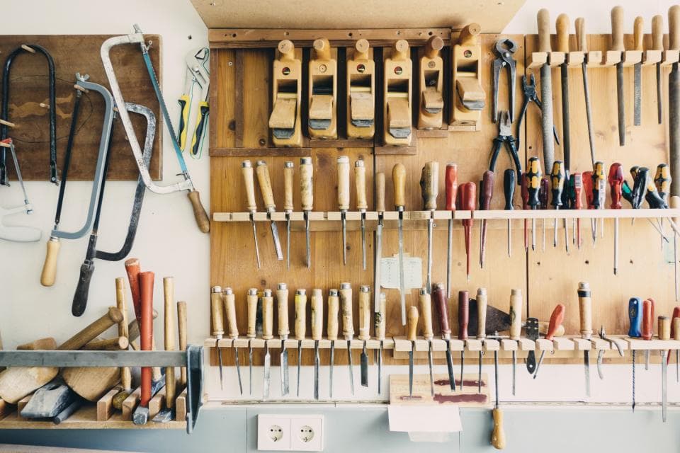 Hand tools hanging on a workshop wall