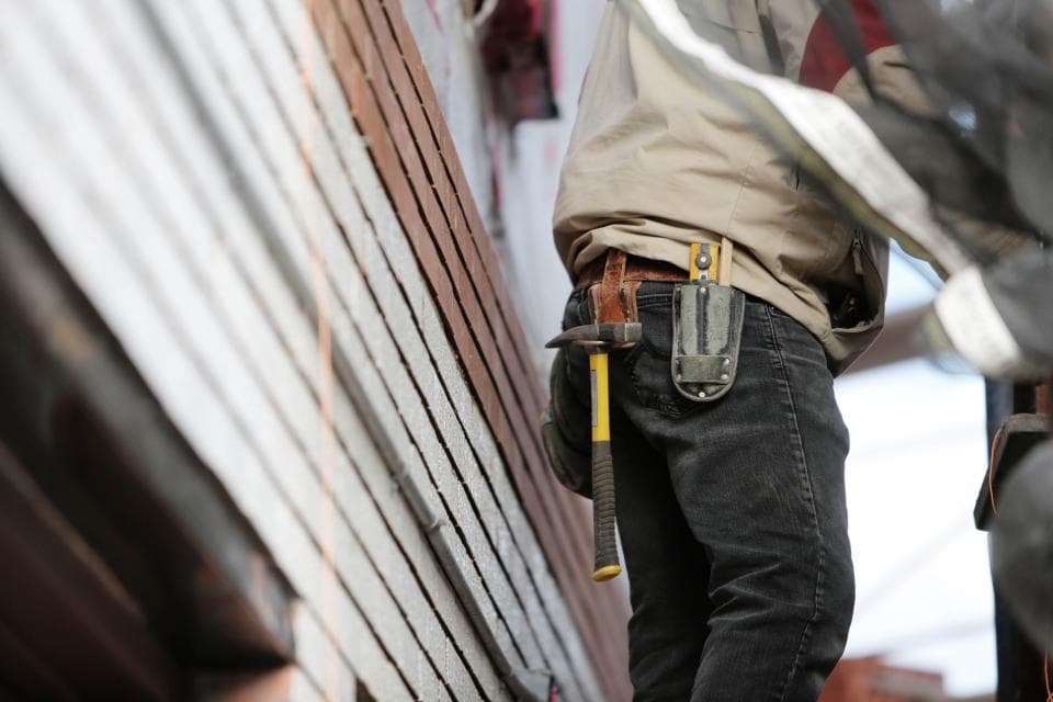 A tradesman with a tool belt at work